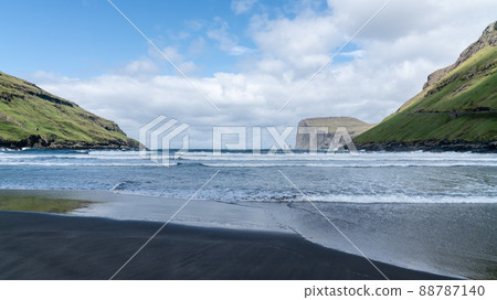 Risin and Kellingin rocks as seen from Tjornuvik bay with waves hitting the shore on Streymoy on the Faroe Islands, Denmark, Europe 88787140