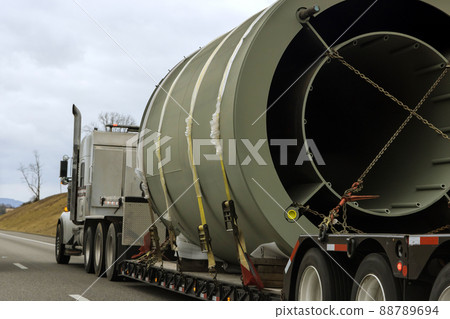 Transportation of bulky goods on a traffic road with a heavy-duty trailer Transportation of bulky goods on a traffic road with a heavy-duty trailer 88789694
