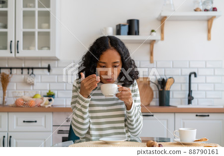 African-american woman having long covid syndrome. Loss of smell concept. Lack of coffee flavor African-american woman having long covid syndrome. Loss of smell concept. Lack of coffee flavor 88790161