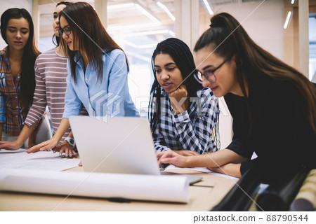 Thoughtful coworkers using laptop for work Thoughtful coworkers using laptop for work 88790544