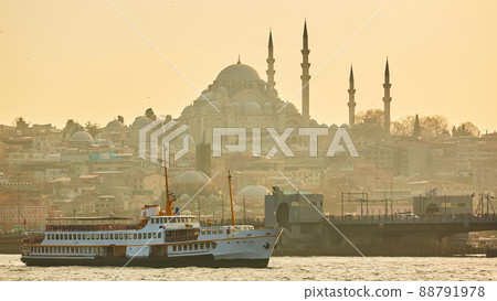 Tourist boat sails on the Golden Horn in Istanbul at sunset, Turkey. Tourist boat sails on the Golden Horn in Istanbul at sunset, Turkey. 88791978