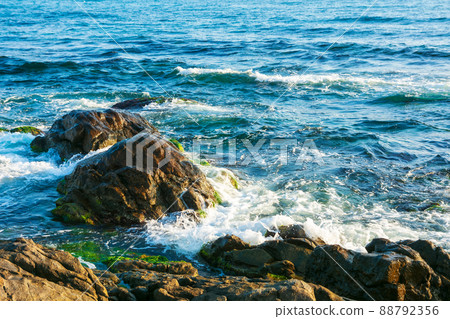 rocky coast in morning light. sea waves crashing over rocks. black sea scenery in summer rocky coast in morning light. sea waves crashing over rocks. black sea scenery in summer 88792356