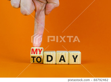 Today is my day symbol. Businessman turns the wooden cube and changes concept words Today to My day. Beautiful orange table orange background, copy space. Business, motivation today is my day concept. 88792462