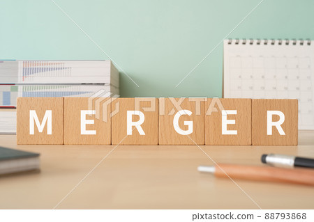 Image of merger | Desk with building blocks with "MERGER" written on it 88793868