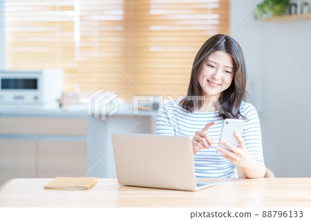 Young woman online in the living room 88796133