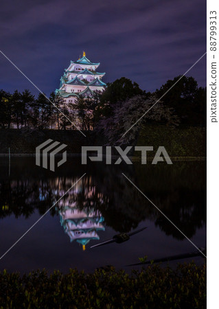 A distant view of Nagoya Castle illuminated in the night sky and the castle reflected in the moat A distant view of Nagoya Castle illuminated in the night sky and the castle reflected in the moat 88799313