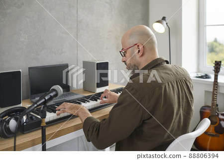 Male musician play on electronic music in studio Male musician play on electronic music in studio 88806394