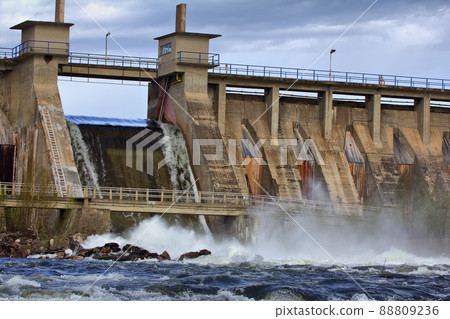 Powerful water discharge through gate of power plant Powerful water discharge through gate of power plant 88809236