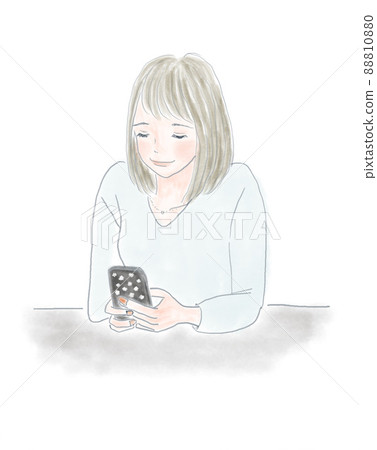 A woman looking at a smartphone at a desk A woman looking at a smartphone at a desk 88810880