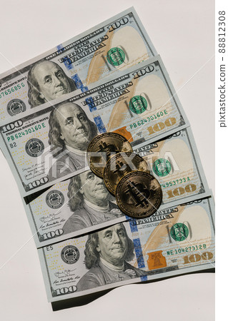 Bitcoin on banknotes of one hundred dollars. Exchange US dollars for bitcoin. Cryptocurrency on dollar bills. Digital modern method of payment. Concep of virtual money Bitcoin on banknotes of one hundred dollars. Exchange US dollars for bitcoin. Cryptocurrency on dollar bills. Digital modern method of payment. Concep of virtual money 88812308
