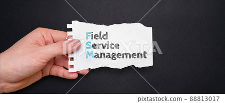 Acronym FSM or Field Service Management. Person holding a piece of paper with text 88813017