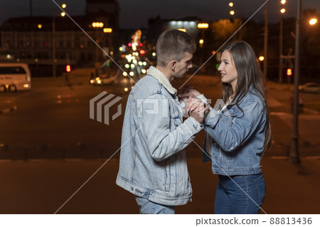 Young couple in love dancing on evening city background Young couple in love dancing on evening city background 88813436