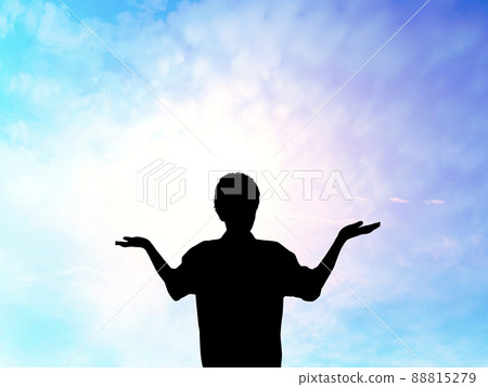 Male silhouette standing with both hands facing up_spiritual sky background Male silhouette standing with both hands facing up_spiritual sky background 88815279