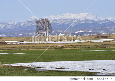 Hokkaido Spring snowy mountains and rural scenery 88815327