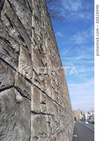 Retaining wall towering over a residential area Retaining wall towering over a residential area 88816046