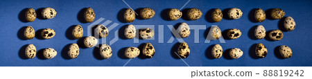 Word EASTER. Creative quail egg layout on blue background. Quail eggs pattern. Happy easter concept Word EASTER. Creative quail egg layout on blue background. Quail eggs pattern. Happy easter concept 88819242