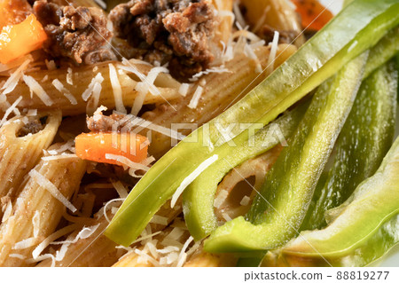 Delicious gourmet pasta with meat and fresh salad. Macaroni with green bell pepper. Delicious gourmet pasta with meat and fresh salad. Macaroni with green bell pepper. 88819277