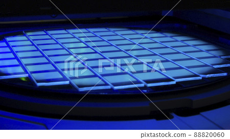 Silicon wafer with chips in UV lighting. Neon. Ultraviolet Lithography. Silicon wafer with chips in UV lighting. Neon. Ultraviolet Lithography. 88820060
