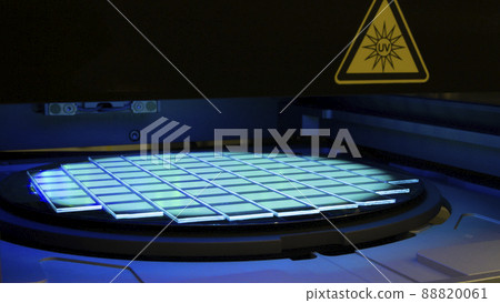 Silicon wafer with chips in UV lighting. Neon. Ultraviolet Lithography. 88820061