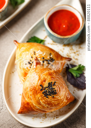 Samosa, samsa meat stuffed pies. Uzbek national dish samosa. Concept of Central Asian, South and East Asian cuisine 88820111