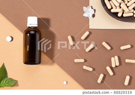 Flat lay composition of various dietary supplements on brown background. Vitamin complexes concept. 88820319