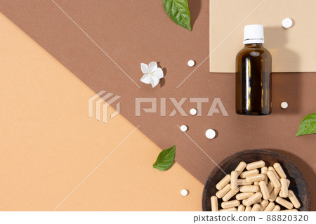 Flat lay composition of various vitamin capsules and dietary supplements on brown background with copy space. Vitamin complexes concept. Flat lay composition of various vitamin capsules and dietary supplements on brown background with copy space. Vitamin complexes concept. 88820320