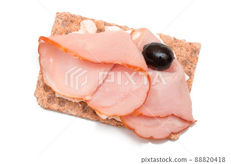 Whole Grain Crispbread with Ham, Cream Cheese and Olives - Isolated Whole Grain Crispbread with Ham, Cream Cheese and Olives - Isolated 88820418
