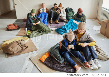 Group of Caucasian People Eating Food in Shelter 88821551