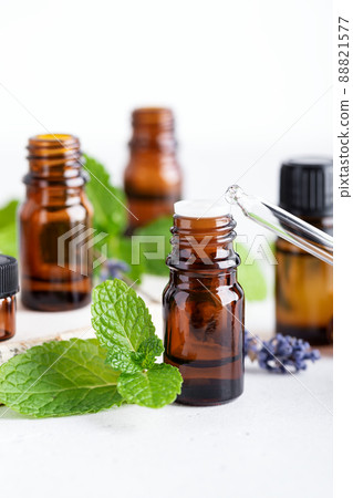 Essential oil in dark amber bottle and glass dropper closeup Essential oil in dark amber bottle and glass dropper closeup 88821577