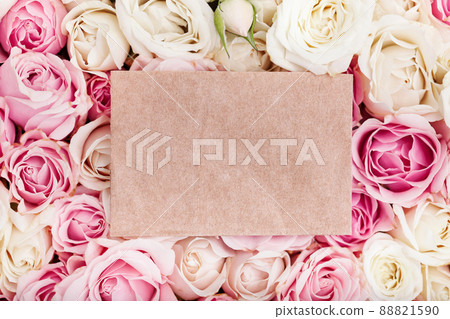 Empty craft paper with copy space on fresh roses background, top view 88821590