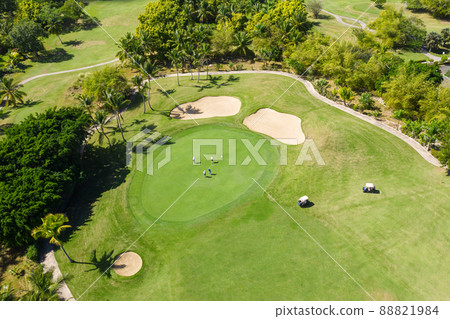 Golf club field with cart and playing golfers. Aerial view Golf club field with cart and playing golfers. Aerial view 88821984
