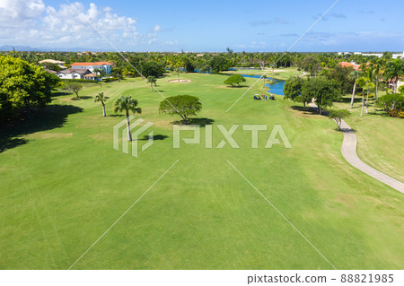 Golf club field with cart and playing golfers. Aerial view Golf club field with cart and playing golfers. Aerial view 88821985