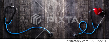 Stethoscope and heart on wooden background. Long banner Stethoscope and heart on wooden background. Long banner 88822291