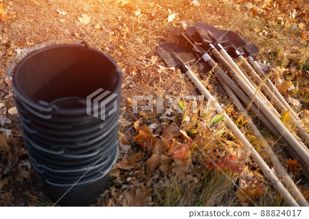 closeup of plastic bucket and shovel on ground or gardening tools for planting closeup of plastic bucket and shovel on ground or gardening tools for planting 88824017