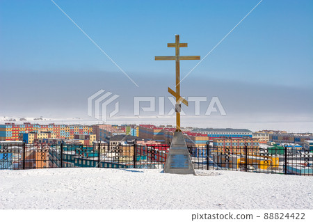 View of the worship cross and the northern city in the Arctic. Large Orthodox cross on the observation deck. View of the worship cross and the northern city in the Arctic. Large Orthodox cross on the observation deck. 88824422
