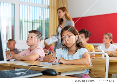 Kids studying in classroom 88826485