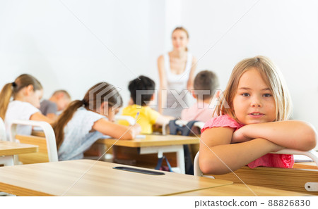Schoolgirl sitting in classroom 88826830