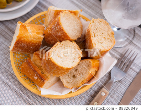 Sliced french baguette on plate in restaurant Sliced french baguette on plate in restaurant 88826849