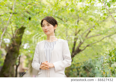 Working woman portrait green background Working woman portrait green background 88827432