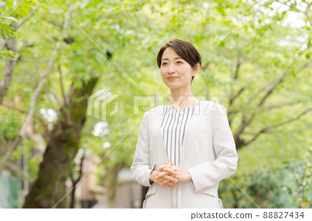 Working woman portrait green background Working woman portrait green background 88827434