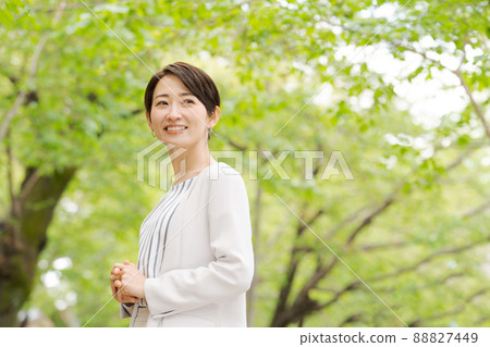Working woman portrait green background 88827449