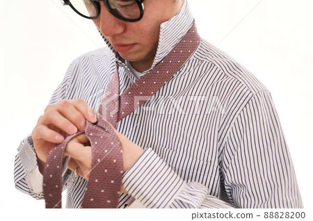Male tying a tie Male tying a tie 88828200