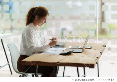 Modern Asian Business woman have confident working with financial at office. Accounting concept. Modern Asian Business woman have confident working with financial at office. Accounting concept. 88828612