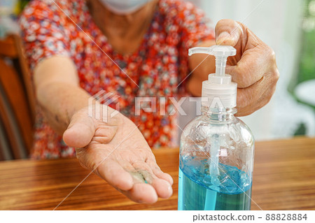 Asian elder senior woman patient wearing a protective mask for protect pollution environment and covid-19 coronavirus. 88828884