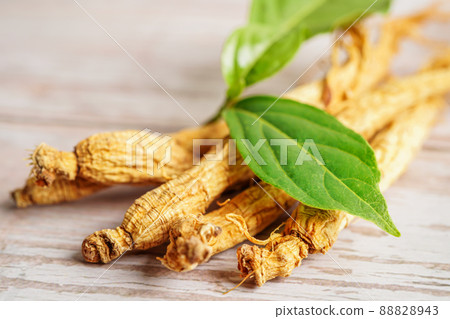 Ginseng roots and green leaf, healthy food. 88828943