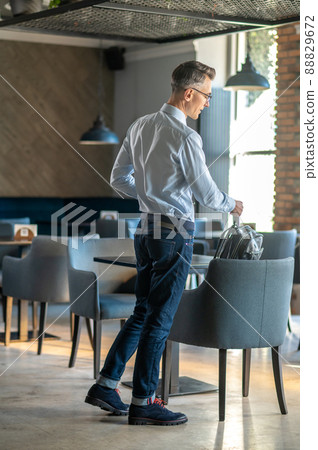 A good-looking man choosing a place in the cafe A good-looking man choosing a place in the cafe 88829672