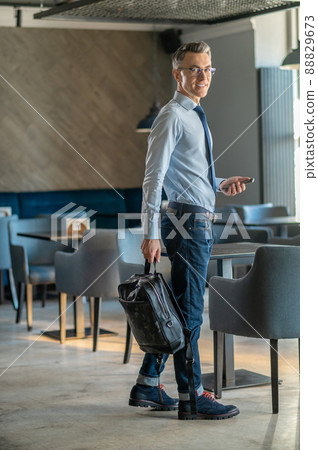 A good-looking man choosing a place in the cafe A good-looking man choosing a place in the cafe 88829673