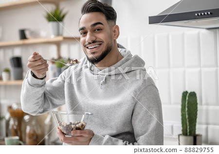 A young man spending morning at home and having coffee A young man spending morning at home and having coffee 88829755