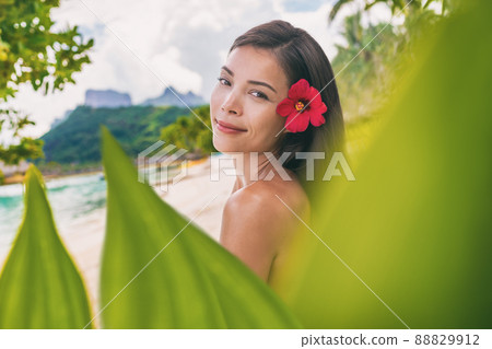 Spa wellness beauty portrait at beach. Serene multiracial woman outdoors at tropical luxury resort. Young mixed race Asian Caucasian female model living Luxury lifestyle looking at camera. Bora Bora 88829912