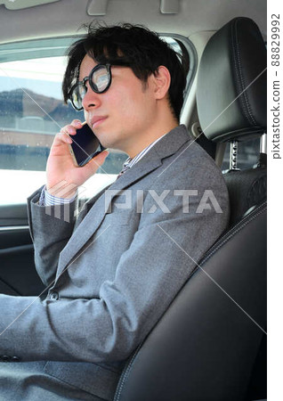Businessman suit sales calling by car Businessman suit sales calling by car 88829992